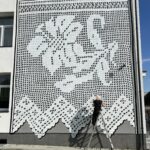 Exposition de dentelle dans l'ancienne église Saint-Gilles à Ambialet - fresque réalisée en Pologne par la street artiste NeSpoon, inspirée de la dentelle d'un tablier issu du costume traditionnel de la région de Kurpie, en Pologne